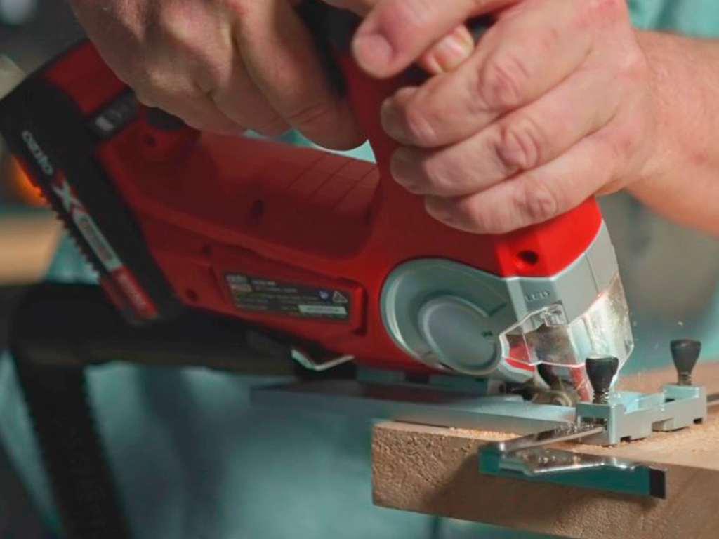 A man is working with a jigsaw