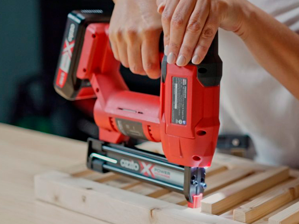 A woman is using a nail gun