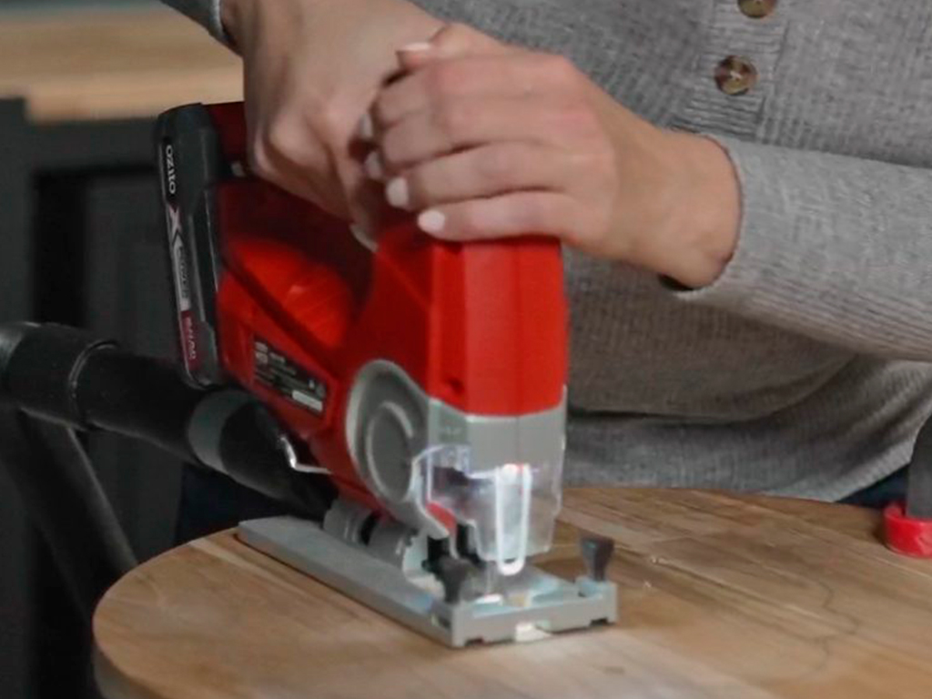 A woman is working with a jigsaw