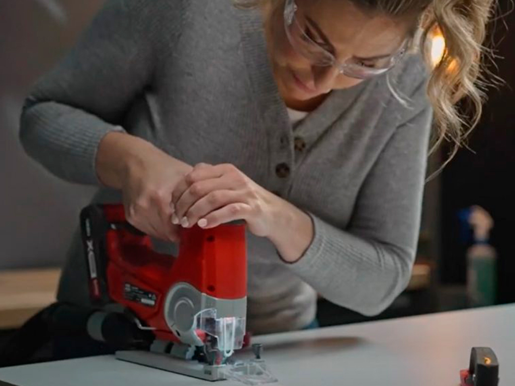 A woman is working with a jigsaw