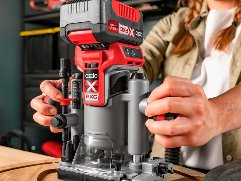 A woman is working with a sander