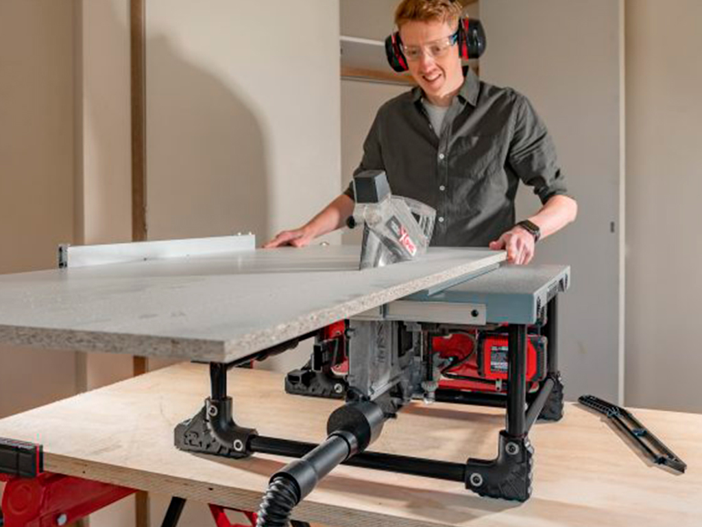 A man is working with a table saw