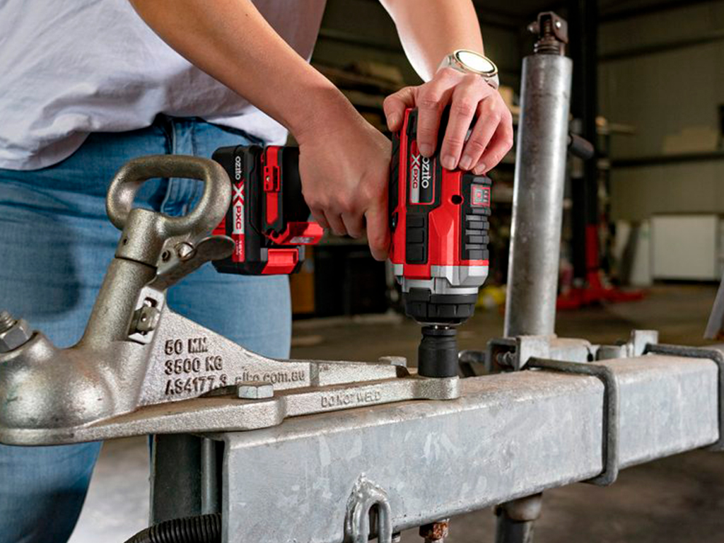 A man is currently working with a cordless impact wrench